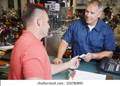 Customer In Motorcycle Shop Paying