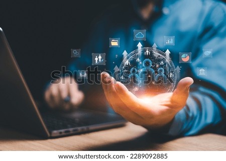 Customer network relationship management concept on virtual screens, Businessman use laptops and hold global structure customer network in hand, Data management and business work development