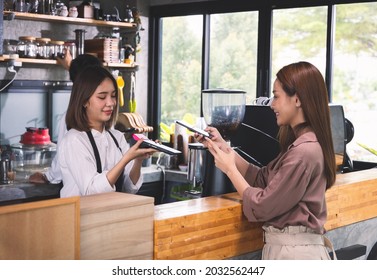 Customer order the hot coffee and payment with smartphone scan. - Powered by Shutterstock