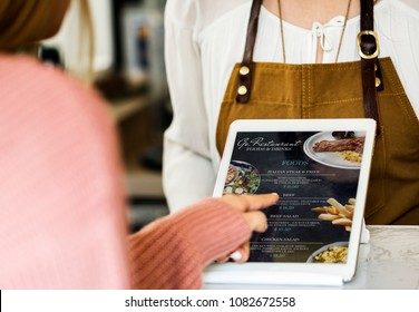 Customer ordering food at restaurant counter - Powered by Shutterstock