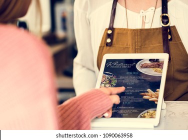 Customer Ordering Food At Restaurant Counter