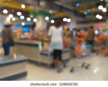 Customer Pay Goods Product At Cashier Checkout Counter In The Supermarket. Blur Background