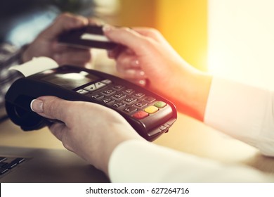 Customer paying with credit card - Shutterstock ID 627264716
