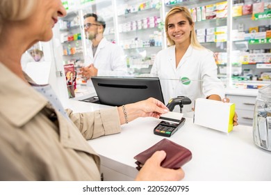 Customer Paying For Medications To Pharmacist In The Pharmacy Store With Credit Card.