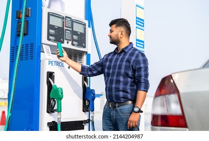 customer paying at pertrol bump by scanning QR code using mobile phone after refuling car - concept of digital contact less payment, wireless transaction and petroleum service