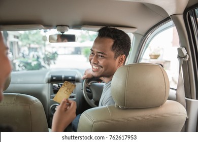 customer paying for taxi. cashless payment in commercial transportation