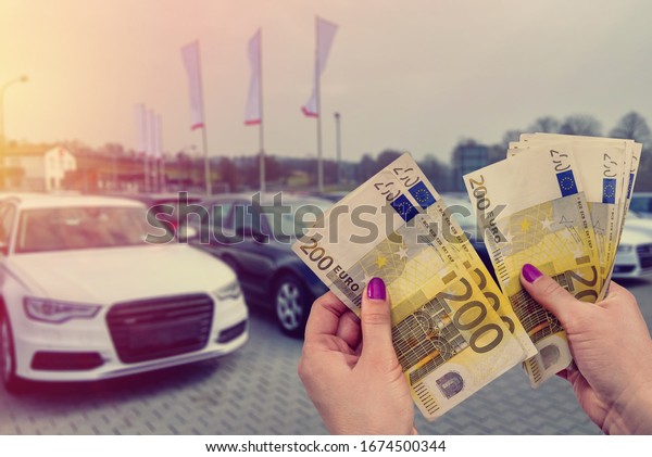 the customer pays euro banknotes for his dream - a\
new car.