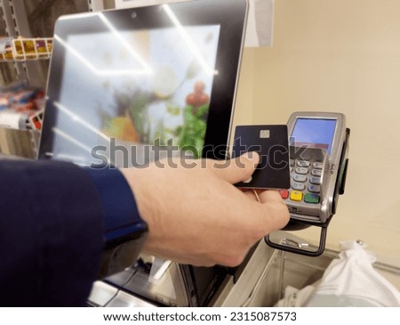 Customer pays his purchase at the supermarket,self checkout systems in  retail stores,Barcode scanner,Self checkout machine