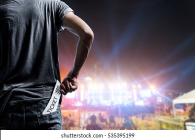 Customer presenting tickets or admission passes watch a rock music concert - Shutterstock ID 535395199