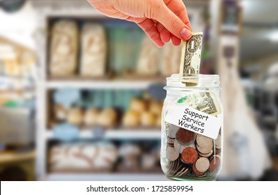 Customer putting money into a Support Service Workers tip jar in a business  -- Showing worker support during the coronavirus pandemic
