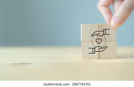 Customer relationship management (CRM) or customer loyalty concept. Customer satisfaction, retention strategies. CRM or customer loyalty program banner. Hand put wooden cubes with holding heart icon.