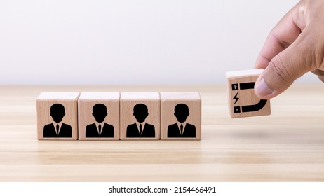 Customer retention concept. Inbound marketing strategy. Attracting potential customers. Hand puts wooden cubes with magnet attracts customer icons on beautiful grey background and copy space.