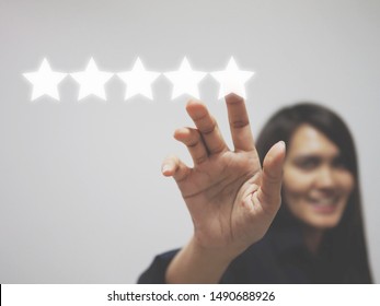 Customer review good rating concept, hand pressing five star on visual screen and  positive customer feedback     