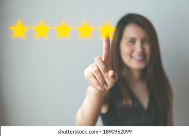 Customer review good rating concept hand pressing five star on visual screen and positive customer feedback testimonial.