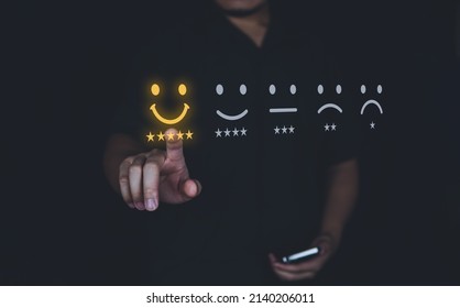 Customer review good rating concept hand pressing smile face icon and five star on visual screen for positive customer feedback, testimonial and testimony. - Shutterstock ID 2140206011
