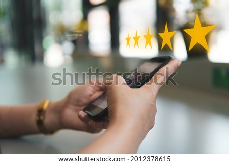 Customer review good rating concept hand pressing five star on visual screen and positive customer feedback testimonial.	
