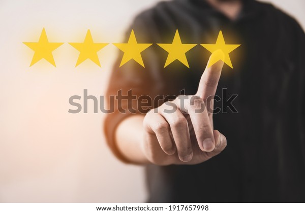 Customer\
review good rating concept hand pressing five star on visual screen\
and positive customer feedback\
testimonial