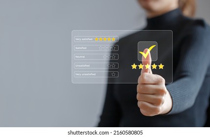 Customer Review Rating And Satisfaction Survey Concept. Customer Give Thumbs Up To The Checkbox And Give It Five-star Satisfaction Rating.