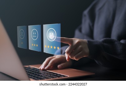 Customer review satisfaction feedback survey concept. Woman using a computer and she is pressing face emoticon smile in satisfaction on virtual touch screen. poll or questionnaire for user experience. - Shutterstock ID 2244322027