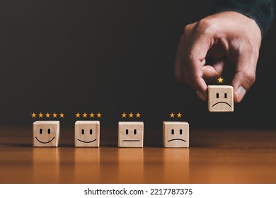 Customer satisfaction assessment, service experience. bad Rated 1 Stars for review. evaluation survey concept. Businessman holding sad face and 1 stars on wood cube block. feedback bad - Shutterstock ID 2217787375