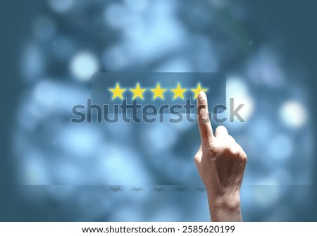 Customer satisfaction concept: Hand pointing at five-star rating on blue background. Symbolizes business excellence, positive feedback, customer reviews, and online reputation.