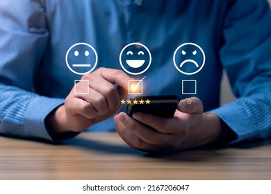Customer satisfaction concept. Hands of a business man using a smartphone to comment 5 stars. Excellent business rating experience. Satisfaction Rating, good and impressive