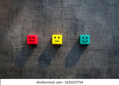 Customer satisfaction measurement unhappy okay and happy faces on coloured red yellow green wood blocks - Commercial business success client rating metrics scale - Excellence, KPI and feedback concept - Shutterstock ID 1632237724