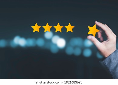 Customer satisfaction and product service evaluation concept , Hand holding and put yellow star to five stars with copy space.
