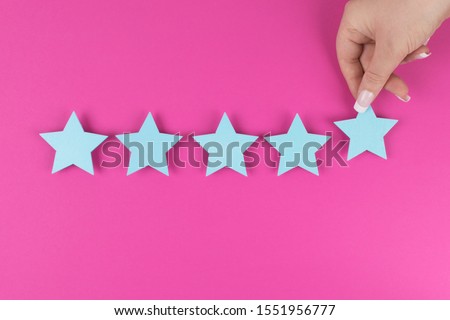 Customer satisfaction survey, excellent services rating concepts. five star symbol, blue stars on pink background, copy space