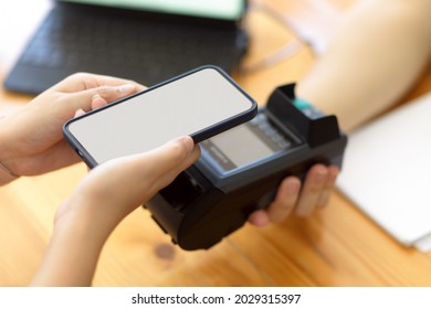 Customer scanning code to pay on payment terminal, cashless society, customer paying at cafe co-working space