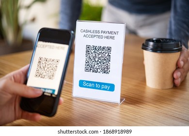 Customer Scanning Tag In Coffee Shop To Pay Online. Close Up Of Hand Scanning Qr Code For Cashless Payment At Cafeteria. Girl Framing Qr Code To Make A Purchase, Small Business Accepts Digital Payment