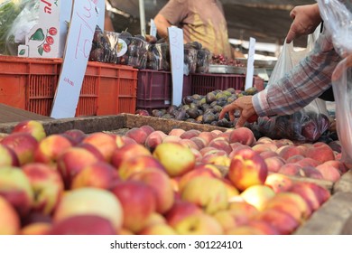 A customer selects a peach