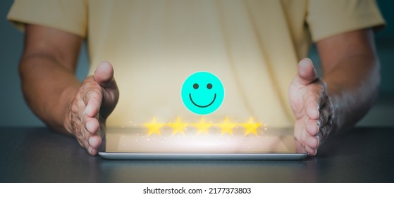 Customer Service Best Business Rating Experience. The Young Man Placed Both Of His Hands Beside The Tablet On The Table. ,The Icon Represents A Great Store Rating.