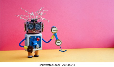 Customer Service Call Center Operator Concept. Friendly Robot Assistant With Retro Styled Phone On Yellow Pink Background. Copy Space Photo.