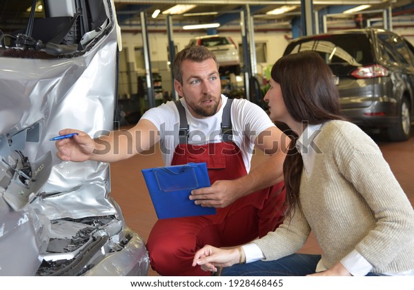 Customer service: car mechanic and woman\
discuss car repair after a traffic accident\
