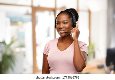 Customer Service, Communication And People Concept - Smiling African American Woman In Headset With Microphone Over Office Background