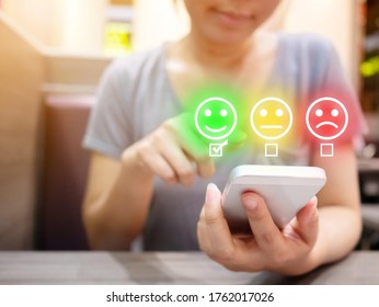 Customer Service Experience and Business Satisfaction Survey. Woman choose face smile on smart phone