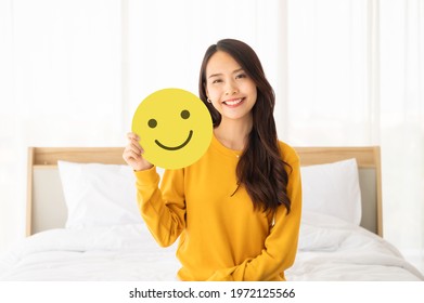 Customer Service Experience And Business Satisfaction Survey. Asian Woman Holding Paper With Smiley Face