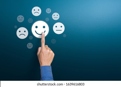 Customer service experience and satisfaction survey concepts. The client's hand choose the happy face smile face with copy space - Shutterstock ID 1639616803