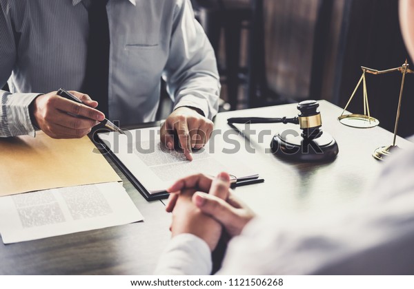 Customer service good\
cooperation, Consultation between a Businessman and Male lawyer or\
judge consult having team meeting with client, Law and Legal\
services concept.