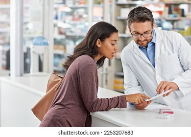 Customer, service and medicine prescription at pharmacy with help from healthcare expert at store counter. Professional advice and opinion of pharmacist helping girl with medication information. - Powered by Shutterstock