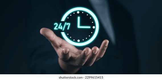 Customer service, nonstop service concept. Businessman hand holding virtual 24-7 with clock on hand for worldwide nonstop and full-time available contact of service concept.