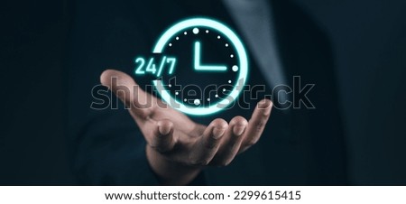 Customer service, nonstop service concept. Businessman hand holding virtual 24-7 with clock on hand for worldwide nonstop and full-time available contact of service concept.