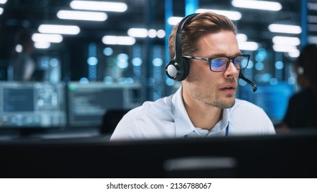 Customer Service Operator at Work in Call Center. Caucasian Call Center Worker Talking with Customer in Modern Office at Night. Worker Speaking on Video Call on Computer Sitting at Table at Office