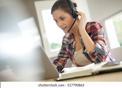 Customer service representative working from home on laptop 