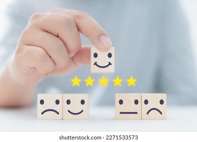 Customer service and satisfaction concept, businessman commenting with smiley face, smiling cube, five star, happy smiley face icon to give service satisfaction. very impressive score