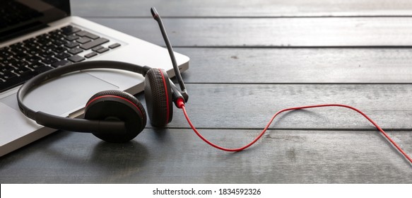 Customer Service Support, Help Desk, Communication. Call Center And Home Office Concept. Headset And Laptop On Blue Wooden Desk, Closeup View, Copy Space,