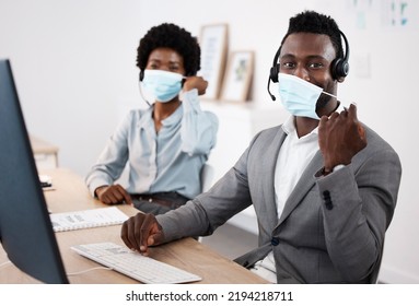 Customer Service Workers With Protection From Covid, Mask And Good Hygiene. Online, Call Center Or IT Hotline Support Employees With Headset, Social Distancing In Corona Virus Pandemic Or Lockdown