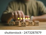 customer services best excellent business rating experience. Satisfaction survey concept. Hand of a businessman chooses a smile face on wood block circle. 5 Star Satisfaction.