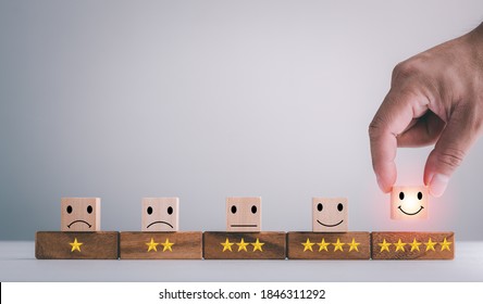customer services best excellent business rating experience. Satisfaction survey concept. Hand of a businessman chooses a smiley face on wood block cube. 5 Star Satisfaction. - Shutterstock ID 1846311292